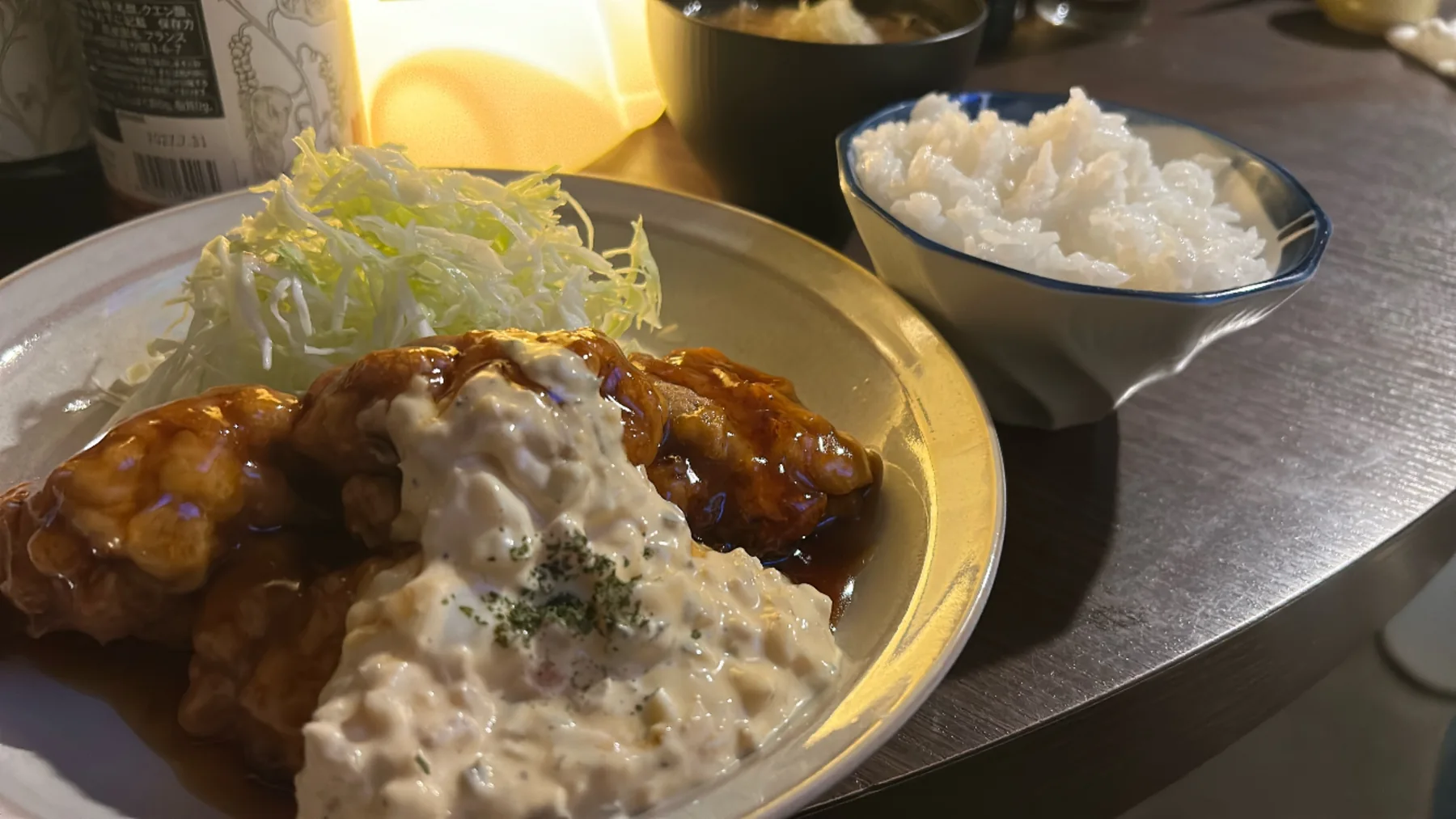 白いソースを添えた料理とごはん